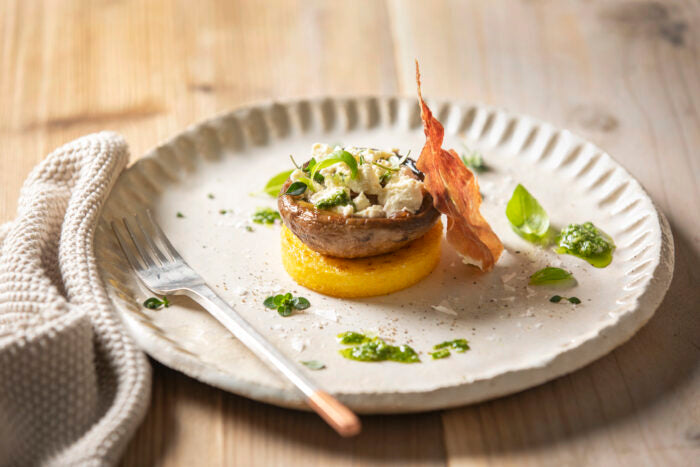 Flame-grilled portobello mushrooms with crispy grilled polenta, lemon thyme, chévre crumb & pesto