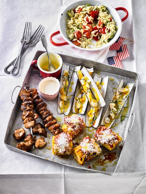 Chicken skewers, razor clams and grilled corn with nduja butter